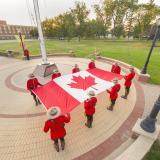 Sunset Retreat Ceremony, Canadian Mounties holding a Canada flag